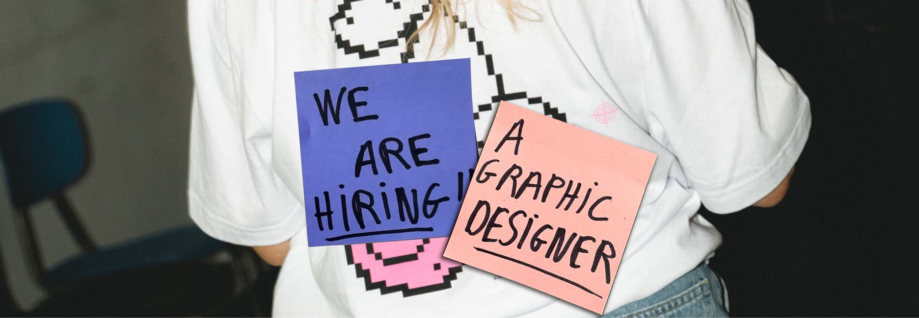 Chukster T-shirt with 'we are hiring a graphic designer' post-it notes stuck on